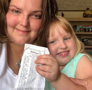 God's Blessing - Holly & Madison holding receipt